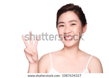 young beautiful asian woman with clean and bright skin,She is smiling and Laugh,happy and playful,Make a gesture,Hold Up three finger ,isolated on white background,beauty concept