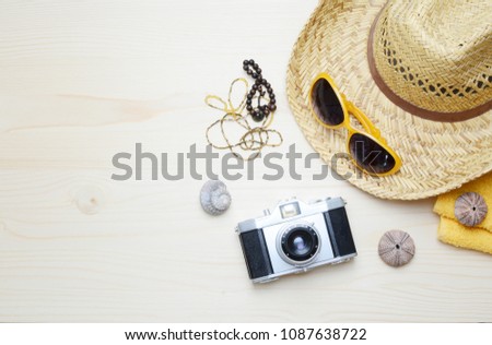 Flat lay image of accessory clothing women to plan travel in holiday, wooden background concept.
