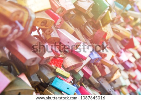 Closed fastened metal wedding locks fastened on bridge in Cologne 
