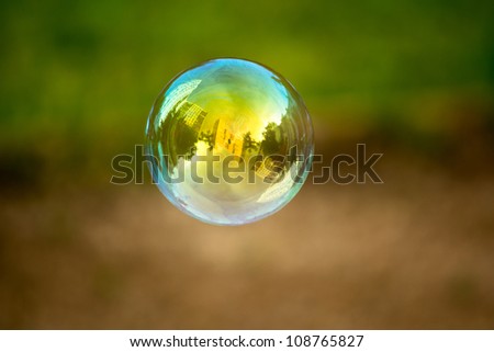 Soap bubble flying. Houses reflected in. Royalty-Free Stock Photo #108765827