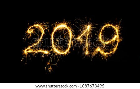 New Year 2019 text handmade written sparkles fireworks. Beautiful Shiny Golden numbers 2019 isolated on black background for design Royalty-Free Stock Photo #1087673495