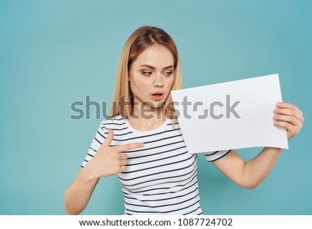 a sheet of paper in the hand of the blonde                      