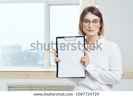 beautiful woman in blouse, folder for documents, paper                             