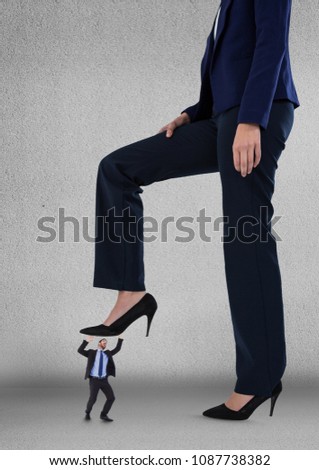 Big business woman trying to step on a small business man