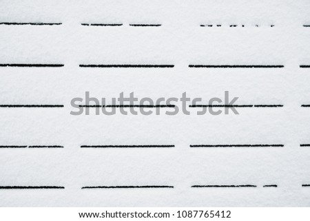 Black straight lines on snow. Snow texture minimalistic pattern. Background