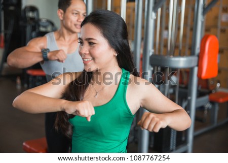 Asian woman warm up for working out in fitness center