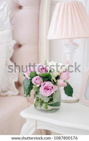 Beautiful roses on a table in a vase, flowers in the room, home cosiness