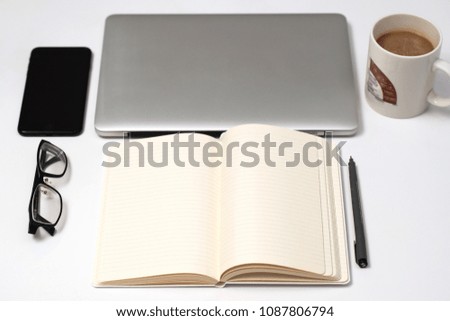 Notebook, pen and Laptop on White background