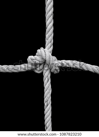 Rope knot on black background. Concept for unity
