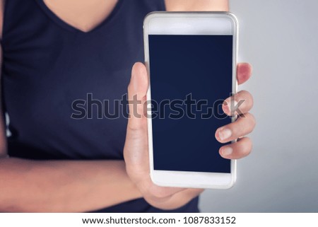 woman in black shirt ad hand 's holding a smart phone