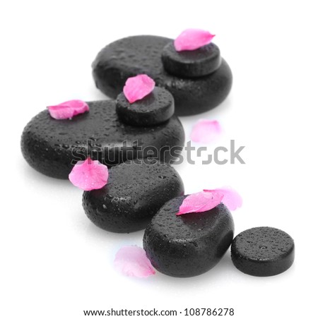 Spa stones with drops and pink petals isolated on white