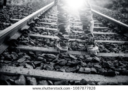 human legs on railway track.  Concept of vigilantism, crime watch,  bullying. 