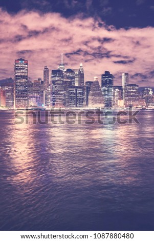 Vintage toned Manhattan skyline at night, New York City, USA.