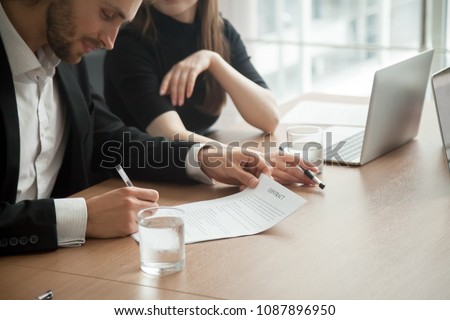Smiling successful businessman in suit signing business contract concept, investor entrepreneur puts signature fills legal official document, customer buys insurance services, client takes bank loan Royalty-Free Stock Photo #1087896950