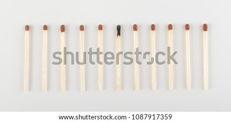 One Burned Match among Many Unburned Ones. Group of Match Sticks or Safety Matches. Individuality and Difference Concept