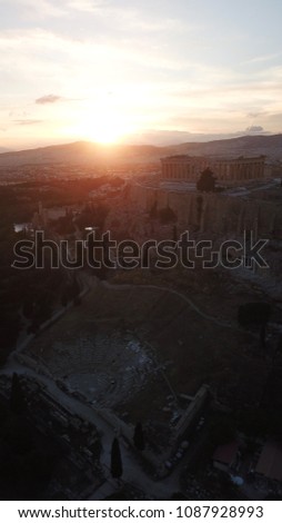 Aerial birds eye view photo taken by drone of iconic Acropolis hill and the Parthenon at sunset with beautiful colours, Athens historic center, Attica, Greece