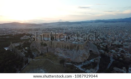 Aerial birds eye view photo taken by drone of iconic Acropolis hill and the Parthenon at sunset with beautiful colours, Athens historic center, Attica, Greece