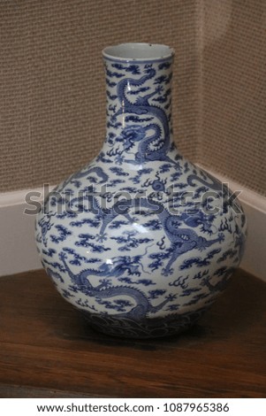 blue and white vase with long neck and round bottom