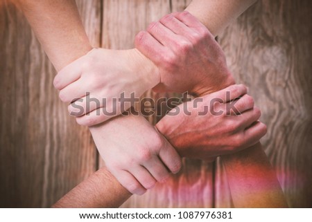 Composite image of cropped image of people forming hand chain