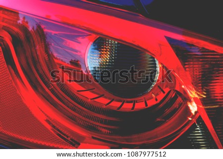 red headlight from car in the form of an eye
