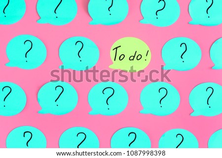 The photo, turquoise stickers with question marks on a pink background. In the center is a green sticker with the inscription To Do. Beautiful bright pattern.