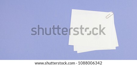 Blank note papers label with clip on purple background