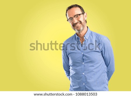 Handsome middle age man confident and happy with a big natural smile laughing, natural expression