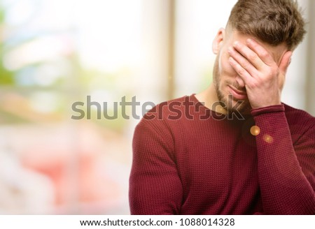 Handsome young man stressful keeping hands on head, tired and frustrated
