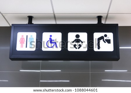 Public toilet sign on ceiling in the airport.