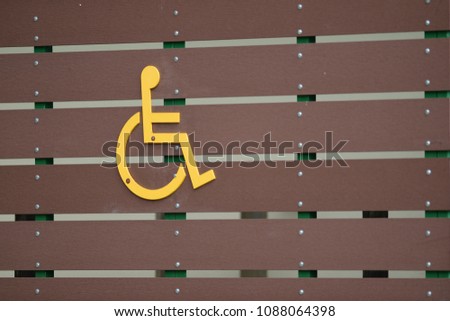 Disabled Handicap Icon, sign on Brown wood background
