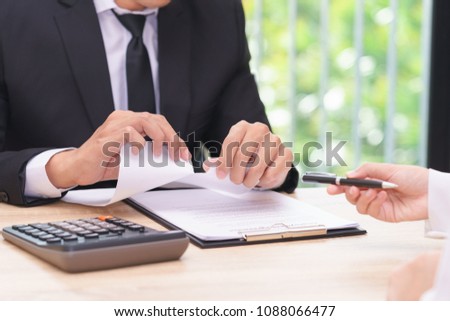 Hands of businessman ripping agreement paper when woman giving a pen for signing, break the rules - failure business concept.