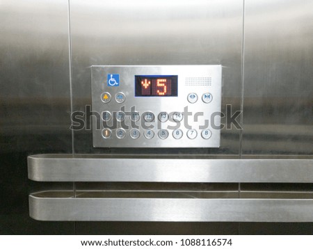 Buttons for elevator with number five, lift going down to fifth floor