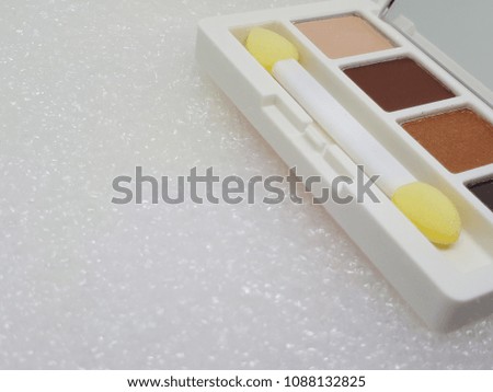 Colorful eye shadow palette make up and brush make up applicator.Isolated on white background.Copy space.Background for cosmetic ,beauty ,make up concept.