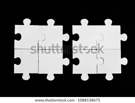 two 2 white paper puzzle, jigsaw on black paper background