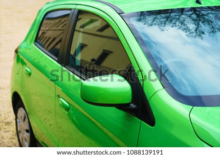 green passenger car stand on european street
