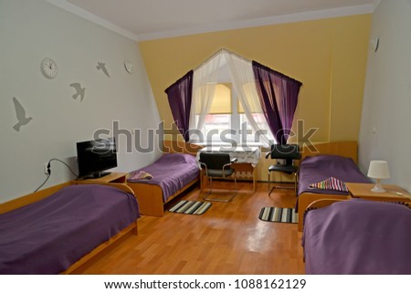 Interior of the quadruple hotel room in violet tones Royalty-Free Stock Photo #1088162129