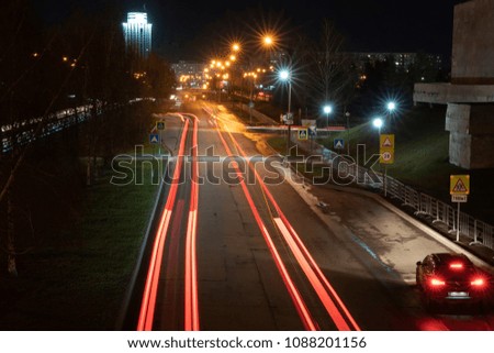Night city. Light marks on the highway.