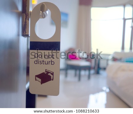 Do not disturb sign at the opened hotel door show the bright clean and fresh morning scene
