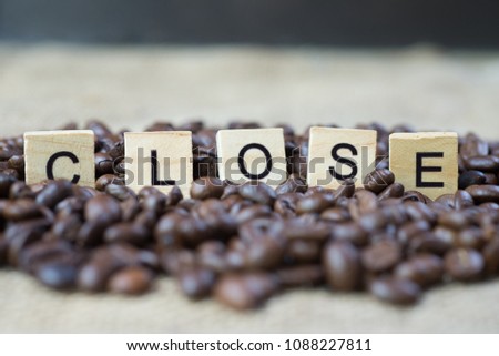 Selective focus of letters close on coffee beans.