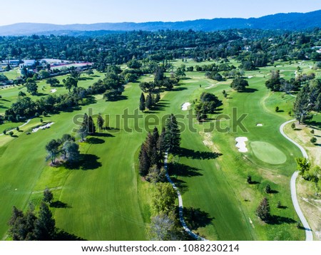 Aerial photograph of forest and golf course.