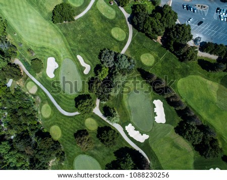 Aerial photograph of golf course and parking lot.