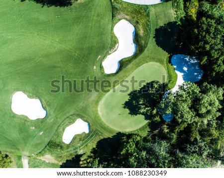 An aerial photograph of a golf course on a sunny day.