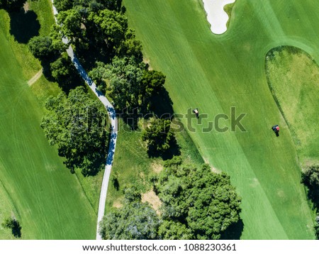 Aerial photograph of golf course and lawnmower.