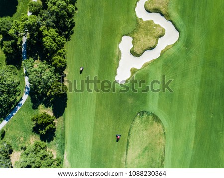 Aerial photograph of golf course and lawnmower.