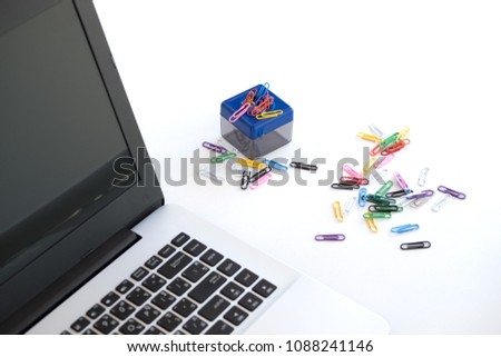 Magnetic box  for put paper clips and Paper Clips colorful on the side of the notebook on white background isolated