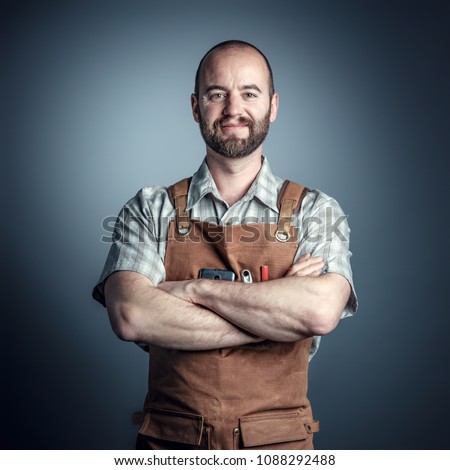 portrait of confident wood worker crossed arms, studio shot Royalty-Free Stock Photo #1088292488