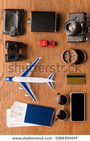 top view of various travel attributes on wooden surface