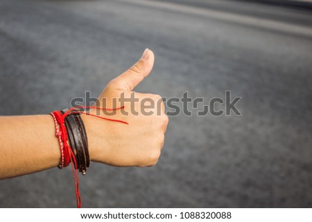 girl hitchhiking hand in travel time on road background