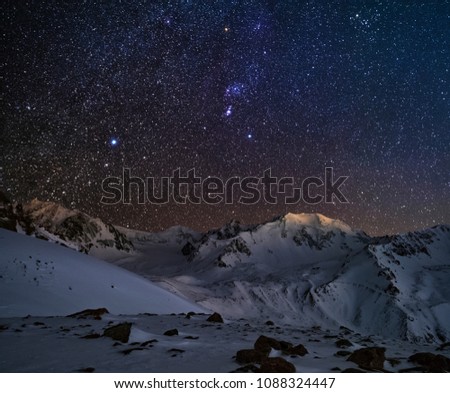 Orion constellation above the mountain peaks