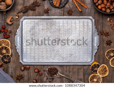 empty square metal dish on a gray wooden background, top view